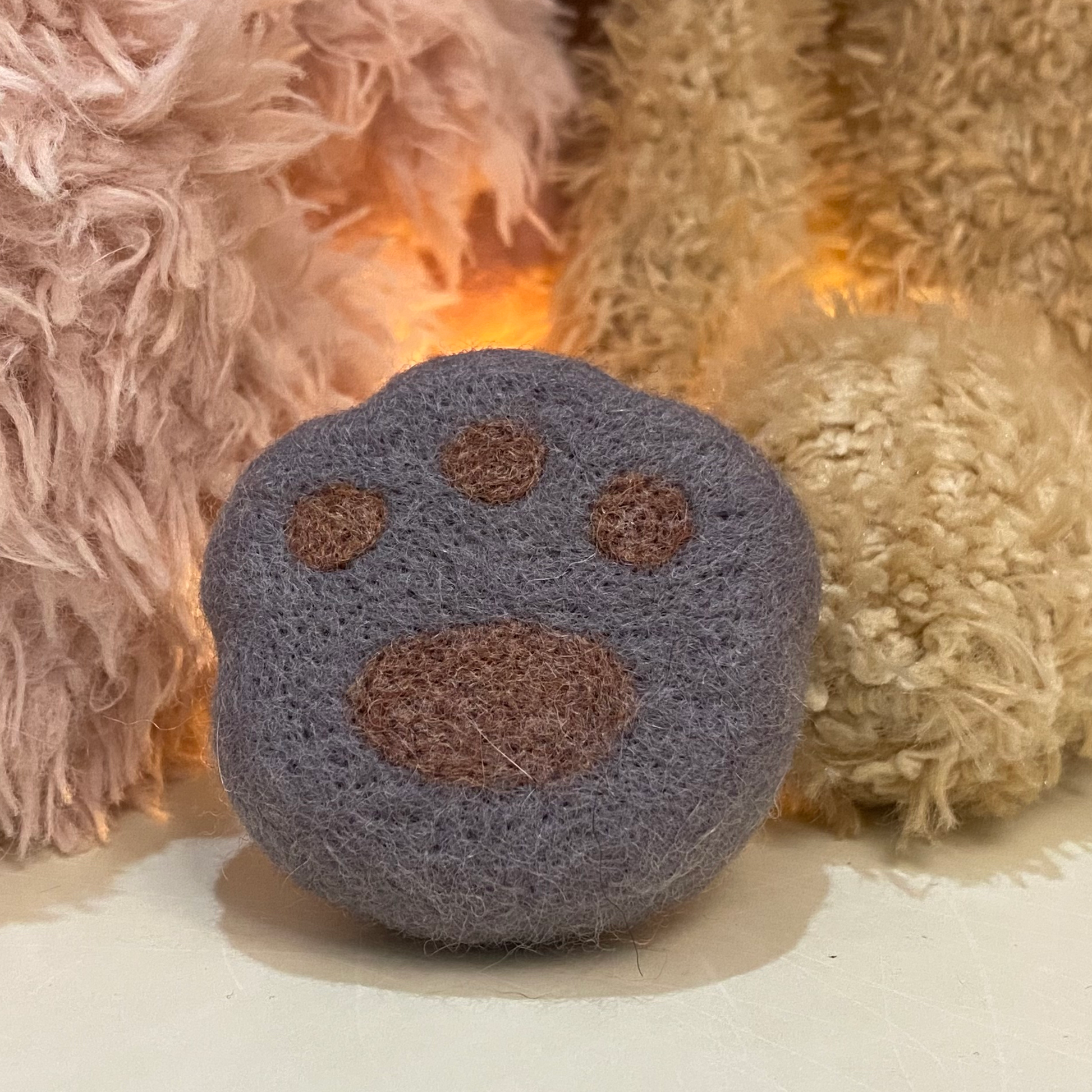 Handmade wool felt fridge magnet shaped like an British Shorthair Blue cat paw, adding a cozy, personal touch for cat lovers