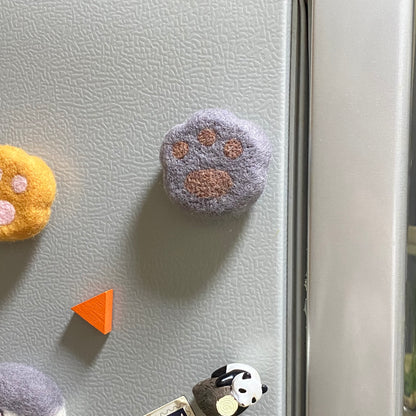 Handmade wool felt fridge magnet shaped like an British Shorthair Blue cat paw, adding a cozy, personal touch for cat lovers