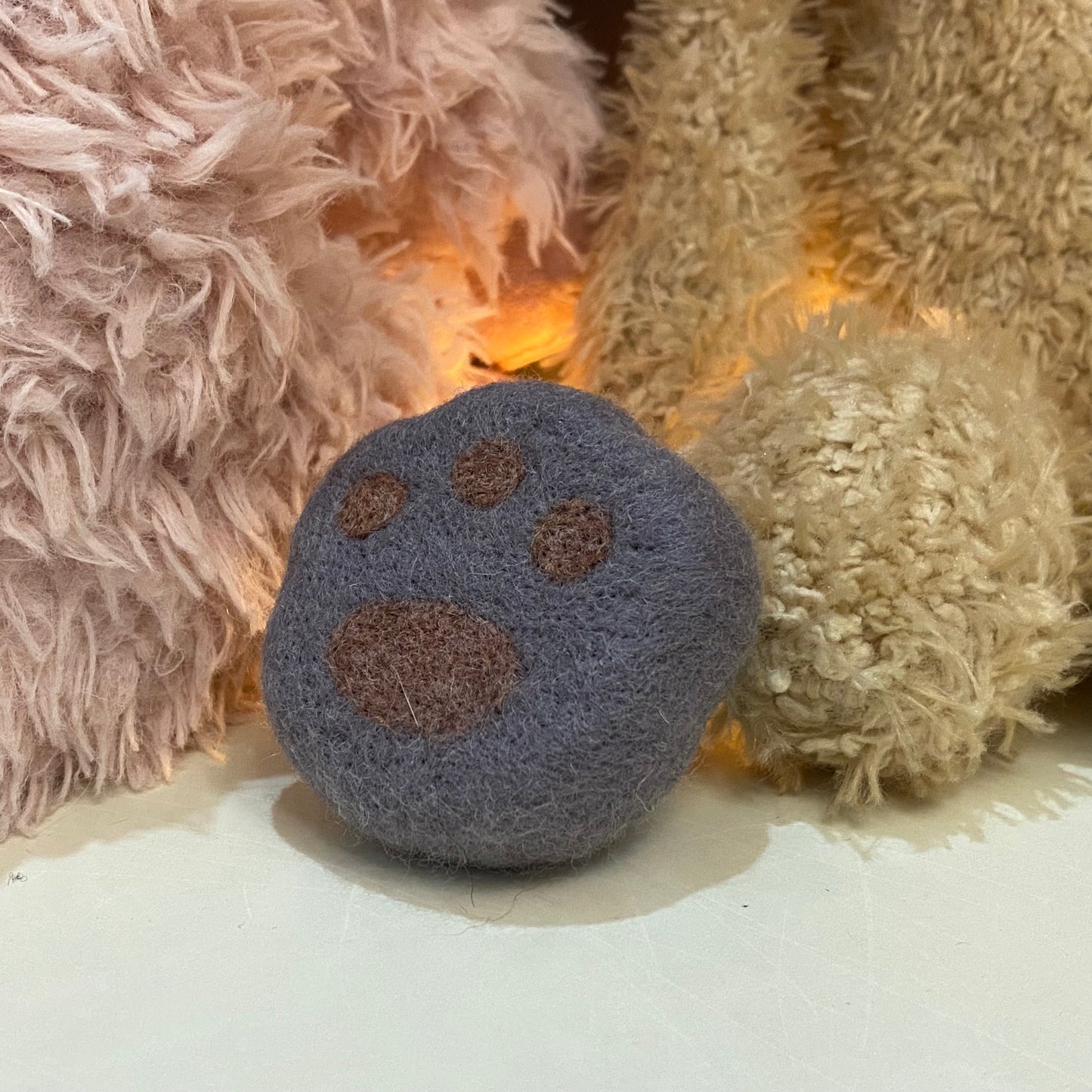 Handmade wool felt fridge magnet shaped like an British Shorthair Blue cat paw, adding a cozy, personal touch for cat lovers