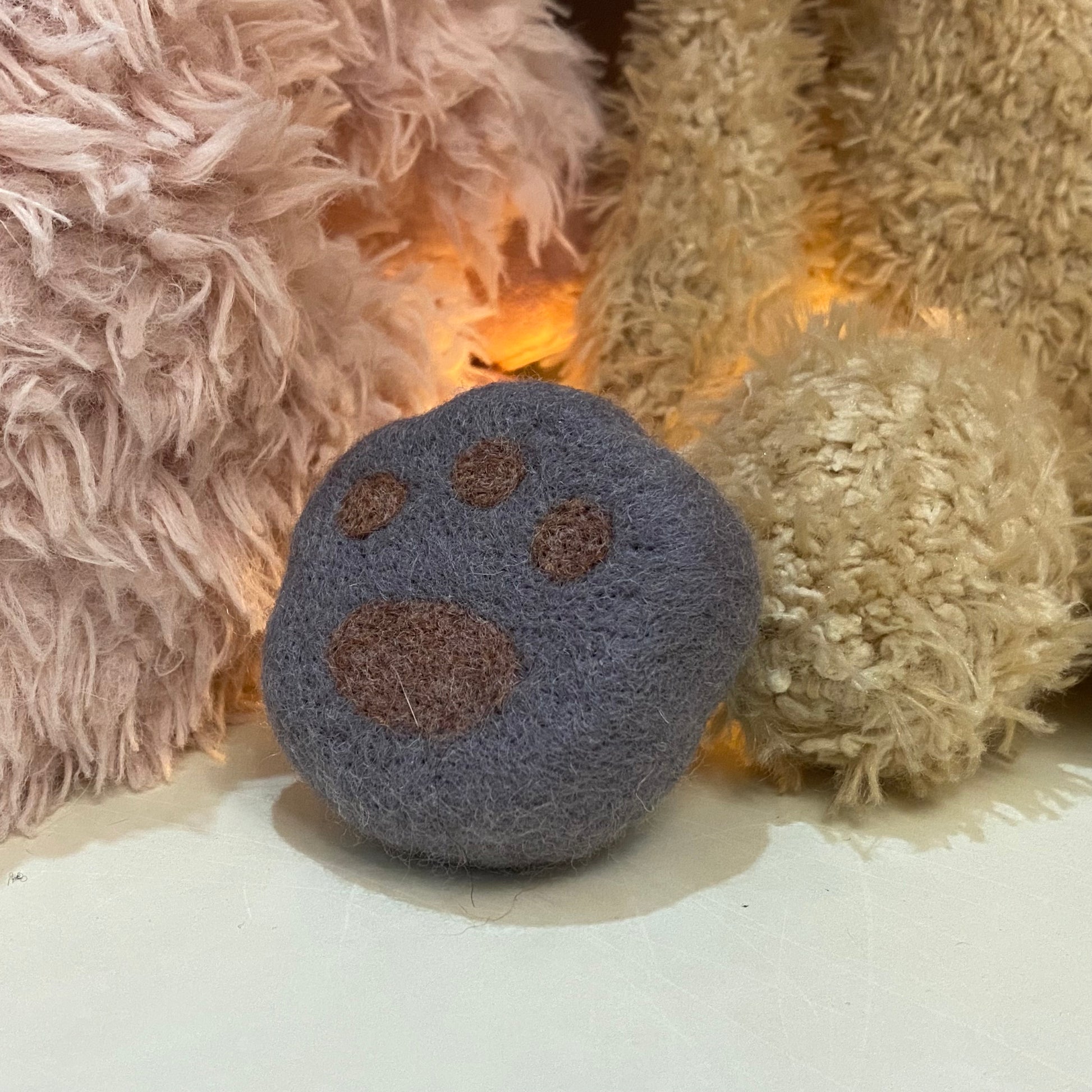 Handmade wool felt fridge magnet shaped like an British Shorthair Blue cat paw, adding a cozy, personal touch for cat lovers