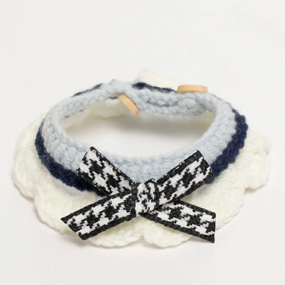 Handmade blue crochet cat collar made from soft yarn, featuring a decorative ribbon.